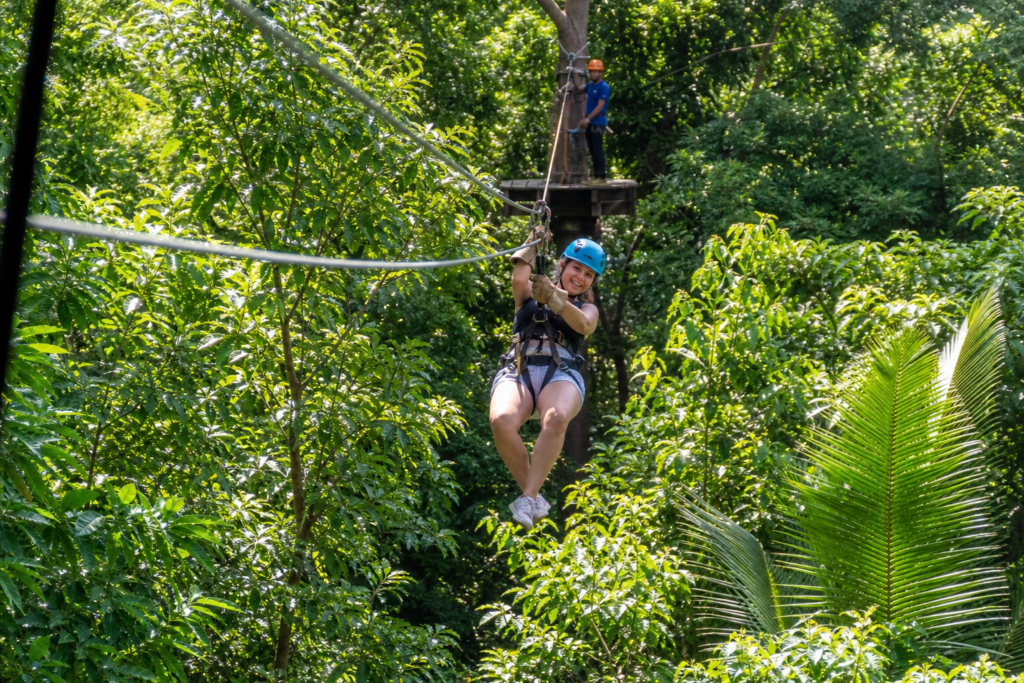 Traveler on a Roatan zipline tour above the jungle canopy
